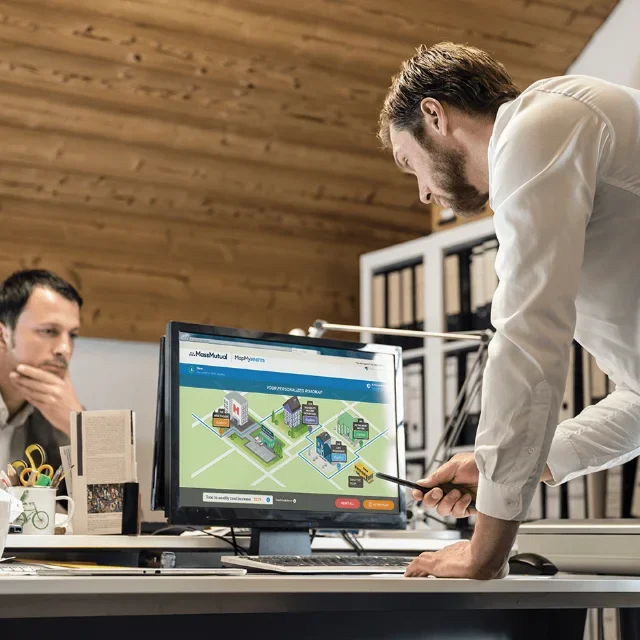 Teammates using computers at desk