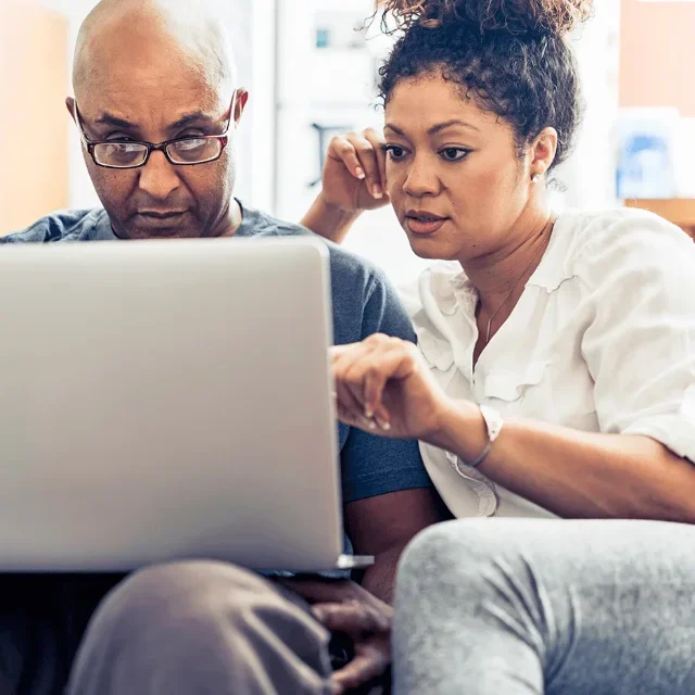 Couple using laptop together